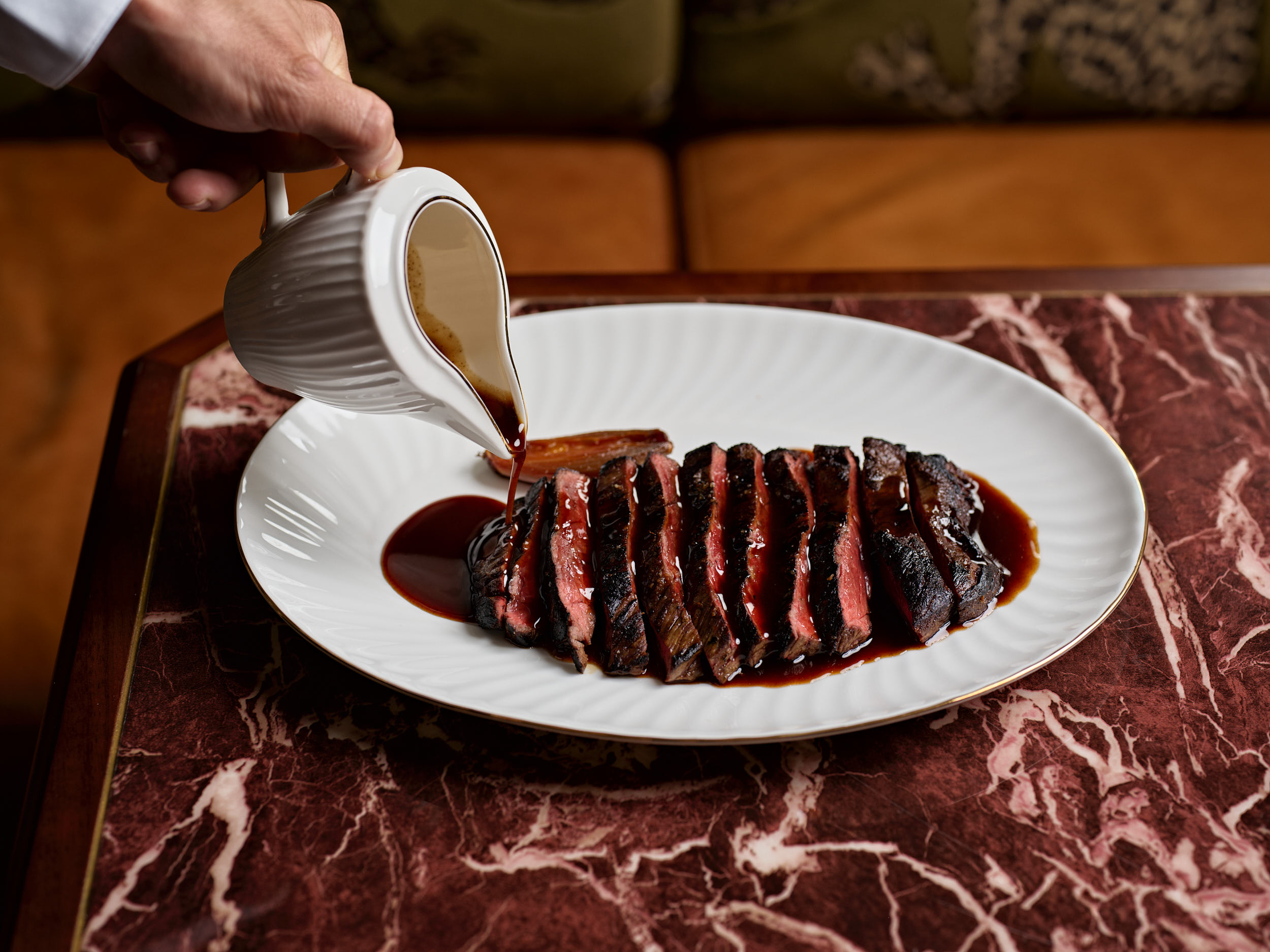 Sliced steak with sauce at Epula